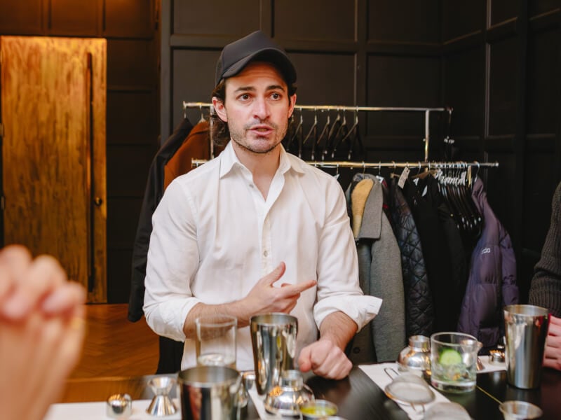 Students learn from their teacher at a cocktail making class